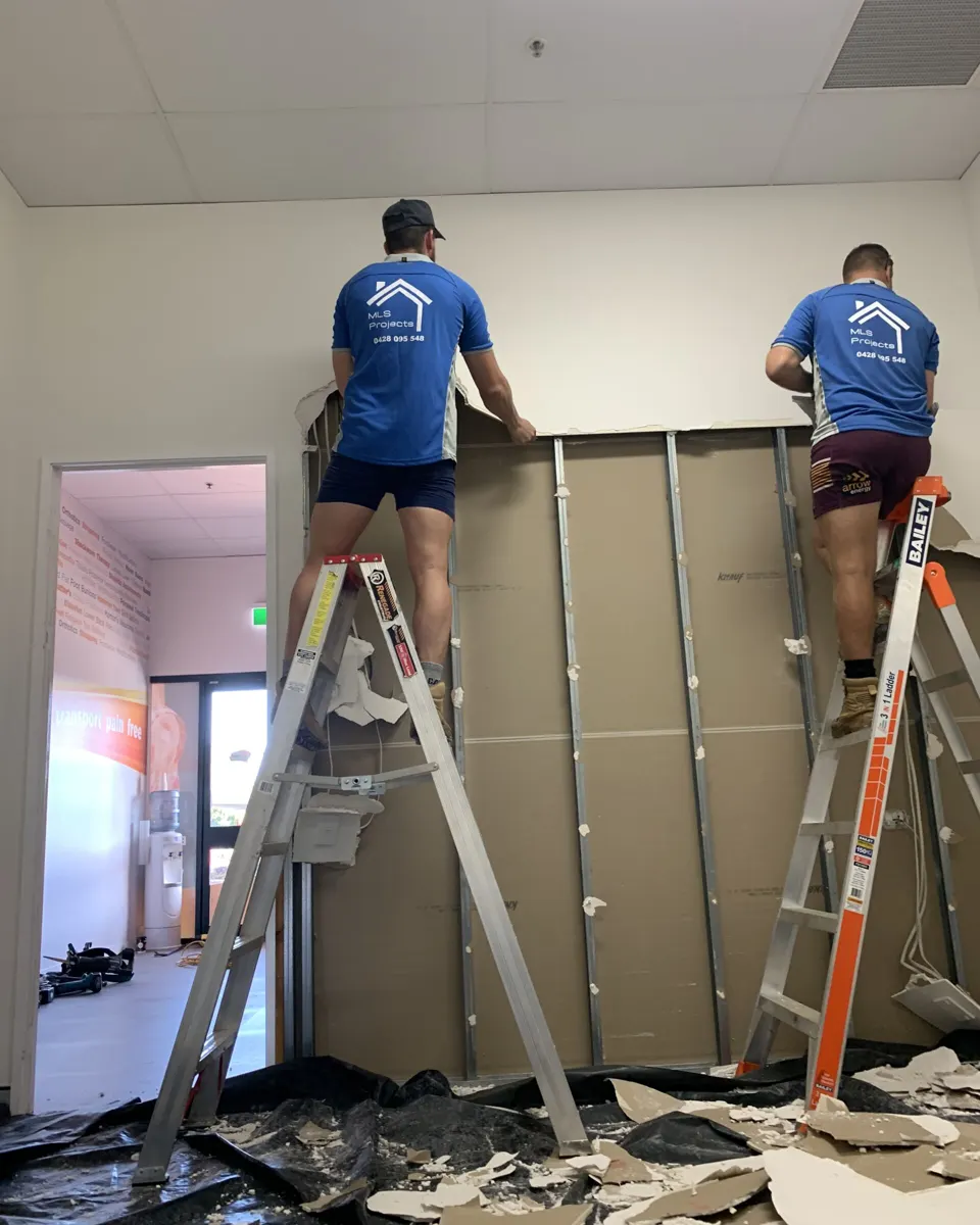 Two MLS Projects carpenters on ladders installing framing during a Cairns fit-out